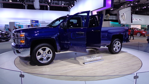 Blue Chevy Silverado truck in a showroom