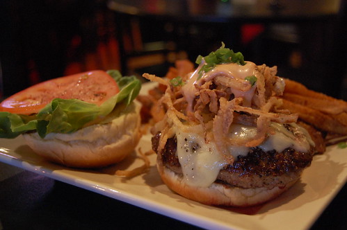 A delicious looking burger with lettuce, tomatoe, fried onion strings and melted cheese from a local Chanhassen, MN. restaurant.