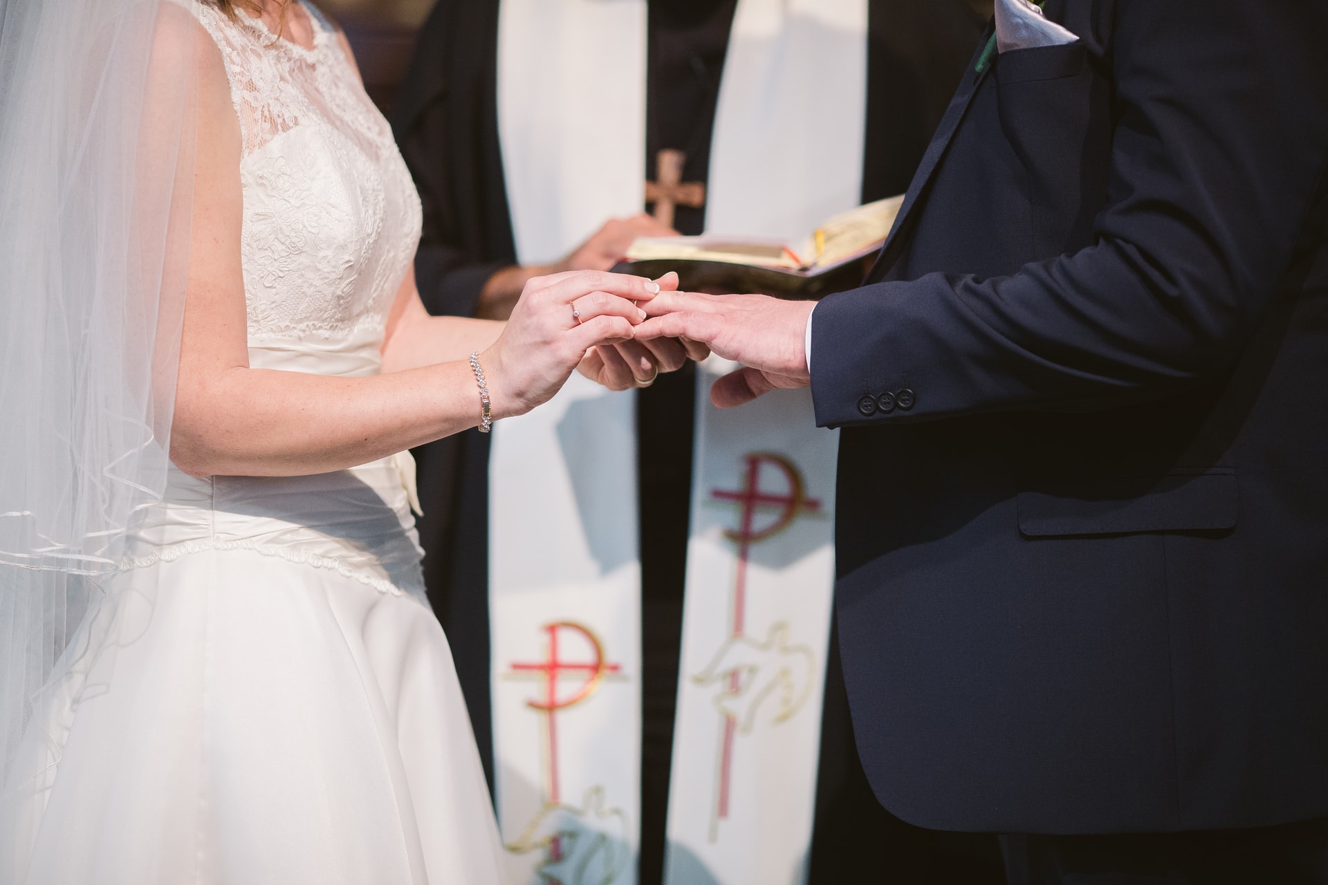 Couple being wedded by Catholic priest