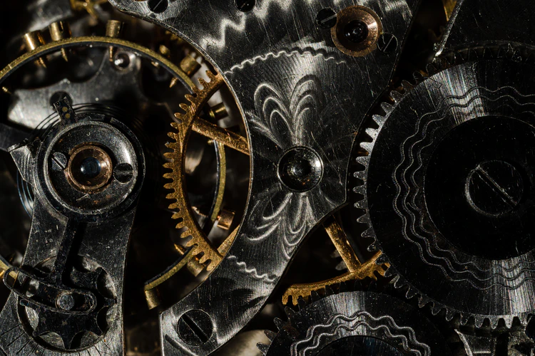 Black and gold gears inside watch, closeup for watch appraisal concept