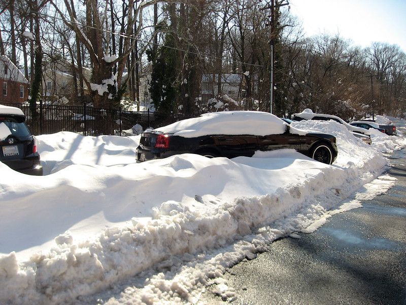 Parked car covered in deep snow