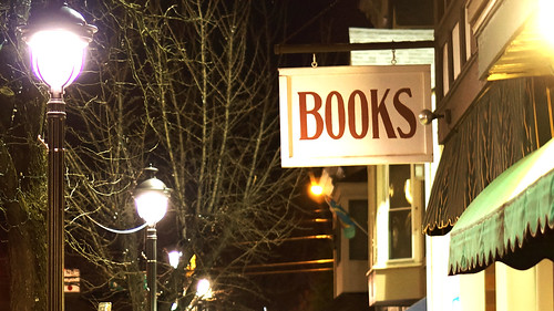 Wooden store sign saying "Books" in red