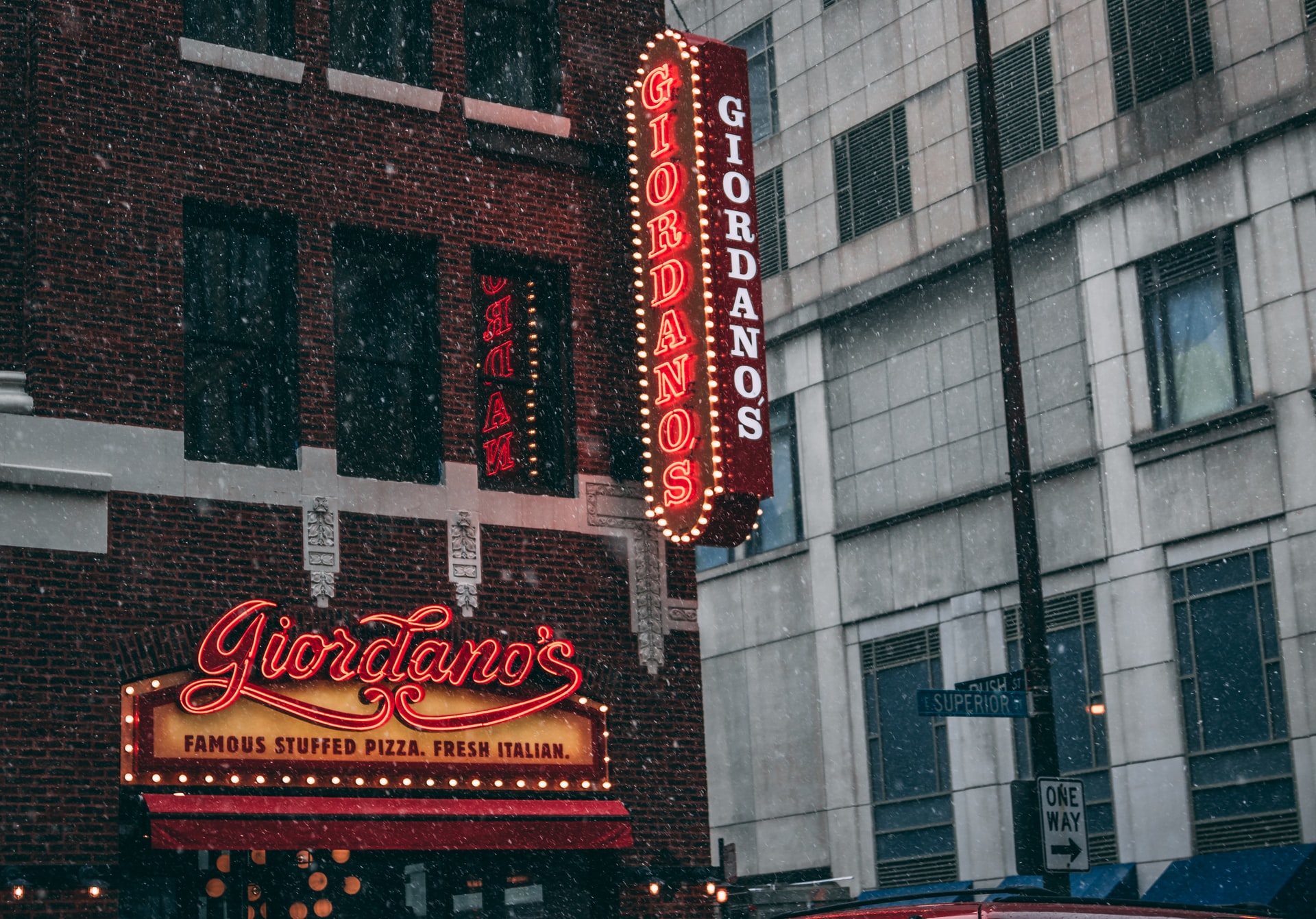 Lit up Giordano's signs at Giordano's restaurant on Superior and Rush in Chicago