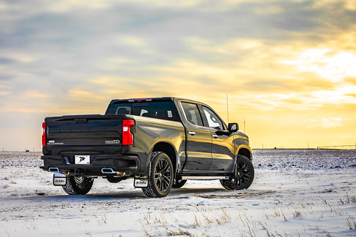 Black Chevy Silverado 1500 on snowy plain at sunrise
