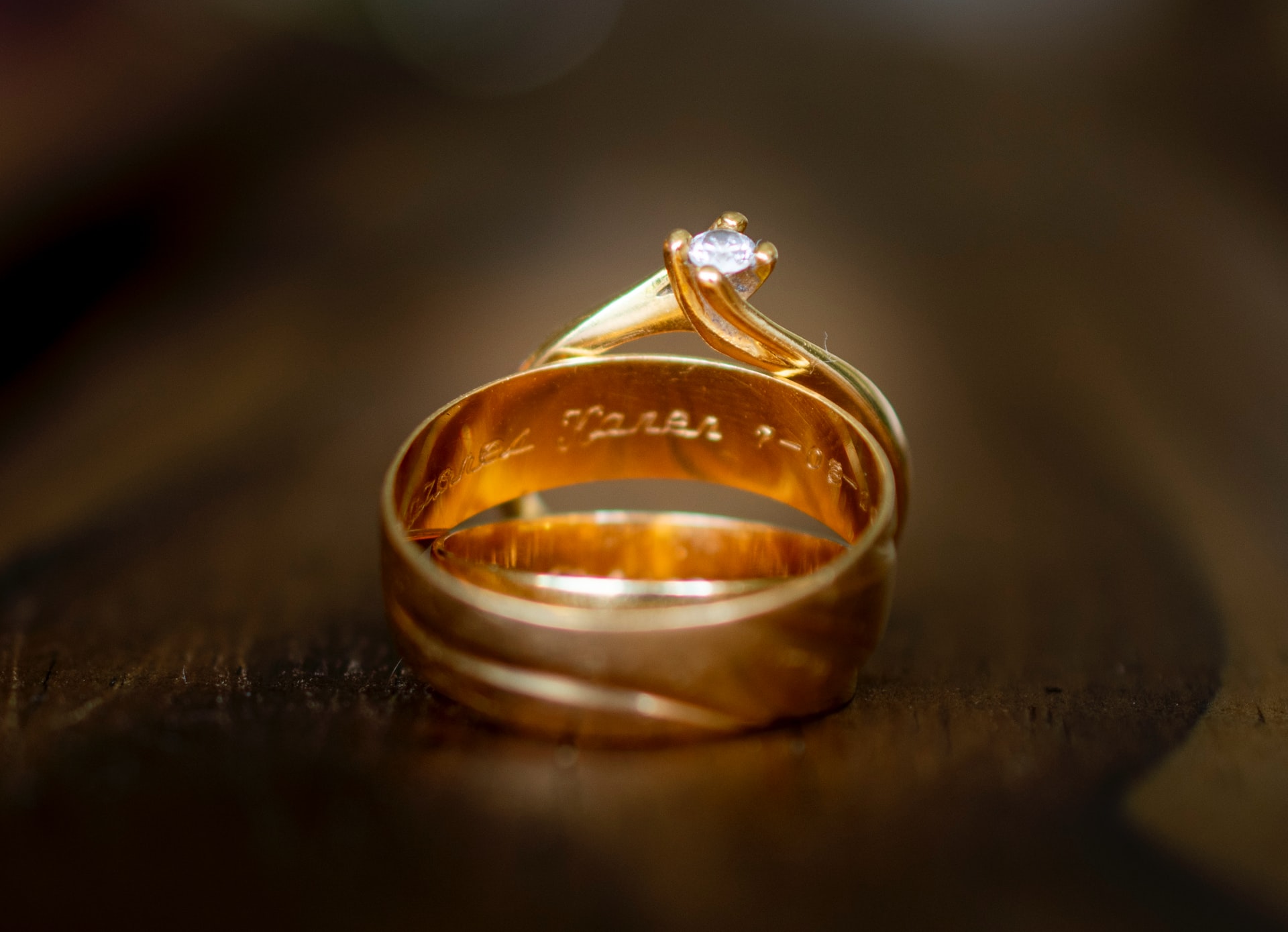 Golden ring with inscription on inside and diamond embedded in it